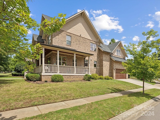 view of front facade featuring a front yard, a porch, and a garage