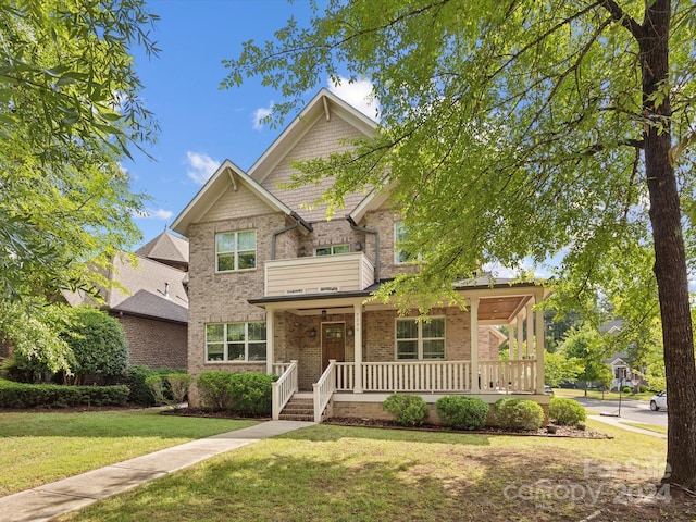 view of front of property with covered porch and a front yard