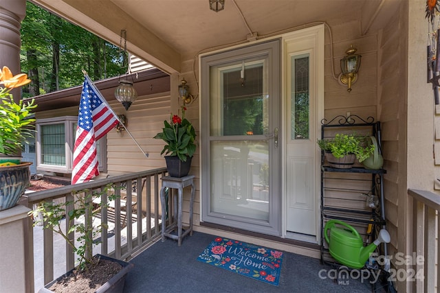 view of exterior entry with a porch