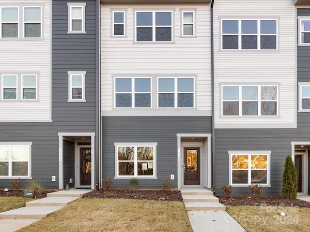 view of property featuring a front yard