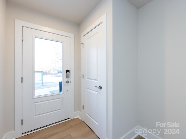 entryway with light wood finished floors