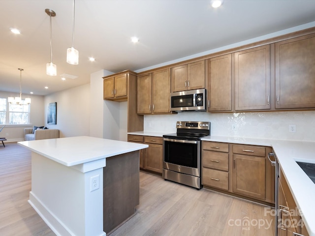 1530 Levy Way, Charlotte, NC 28205 - kitchen featuring stainless steel appliances, light wood finished floors, decorative backsplash, a chandelier, and recessed lighting