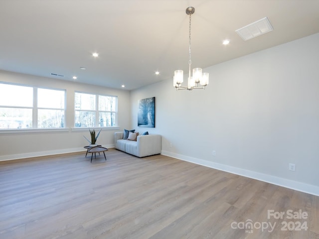 unfurnished room with recessed lighting, visible vents, baseboards, light wood finished floors, and an inviting chandelier