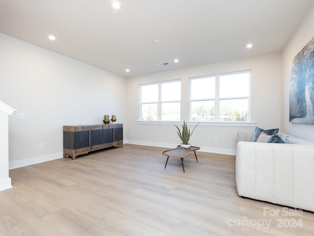 living area with light wood-type flooring, baseboards, visible vents, and recessed lighting