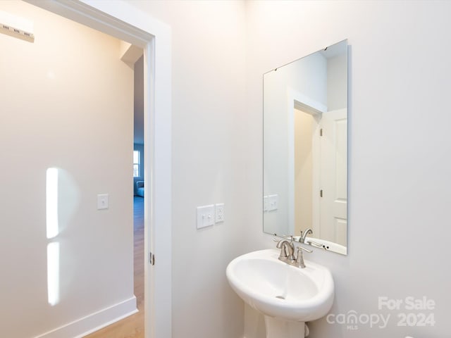 bathroom with baseboards and a sink