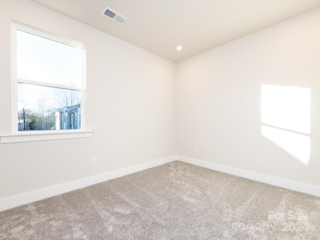 unfurnished room featuring recessed lighting, carpet, visible vents, and baseboards