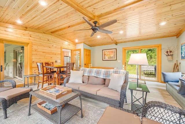 living room featuring wood walls, lofted ceiling, ceiling fan, light hardwood / wood-style floors, and wooden ceiling