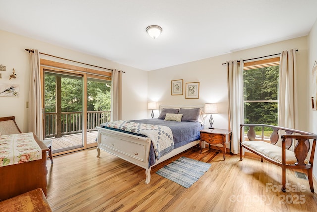 bedroom featuring access to exterior and light hardwood / wood-style floors