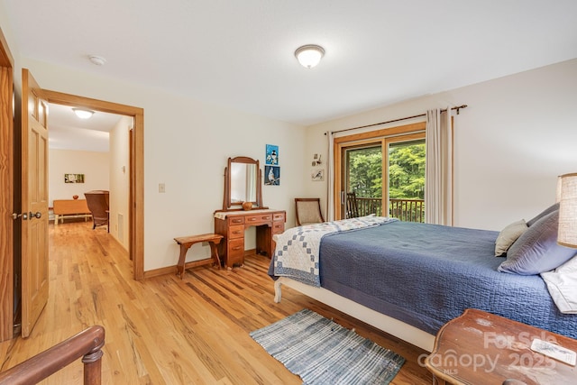 bedroom featuring access to outside and light hardwood / wood-style floors