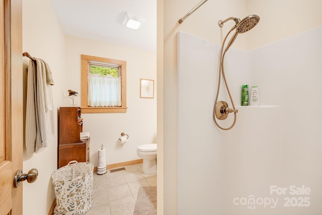 full bath with a shower, baseboards, toilet, and tile patterned flooring