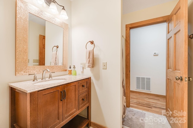 bathroom with hardwood / wood-style flooring and vanity