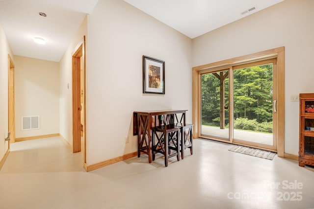 dining room with visible vents, concrete flooring, and baseboards