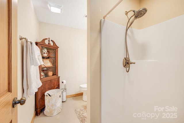 bathroom featuring toilet and walk in shower