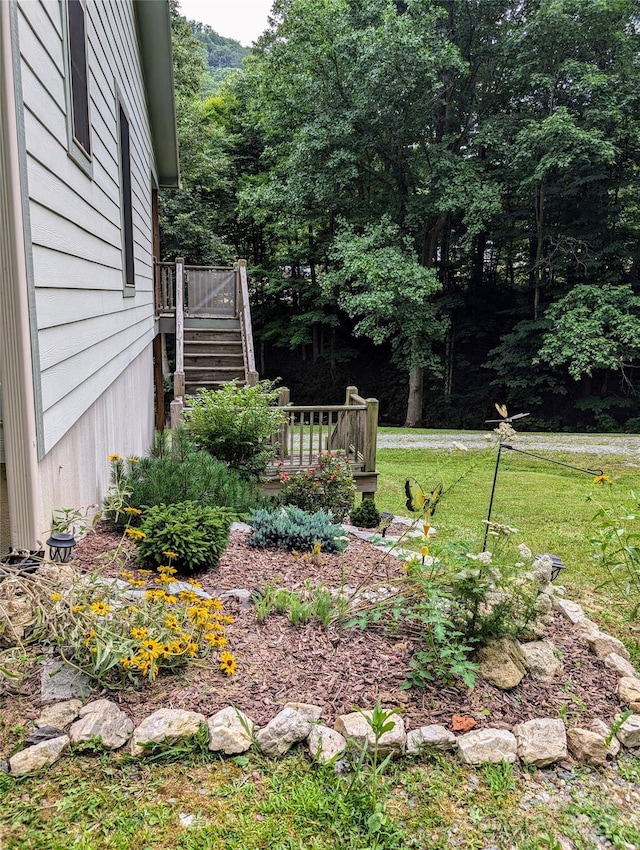 view of yard with a deck and stairway