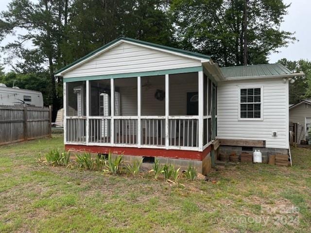 back of property featuring a lawn