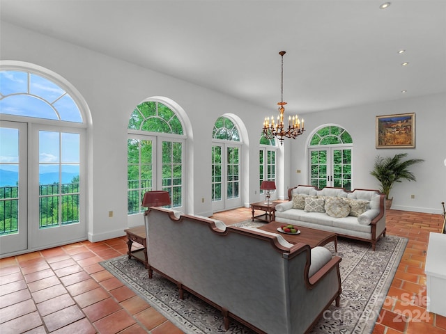 living room with light tile patterned flooring, a chandelier, and french doors