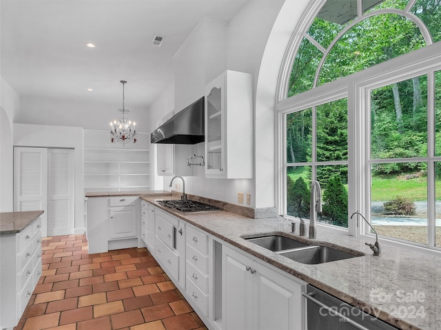 kitchen with sink, stainless steel appliances, extractor fan, light stone countertops, and white cabinets