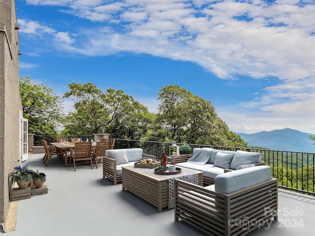 view of patio / terrace with a mountain view and an outdoor hangout area