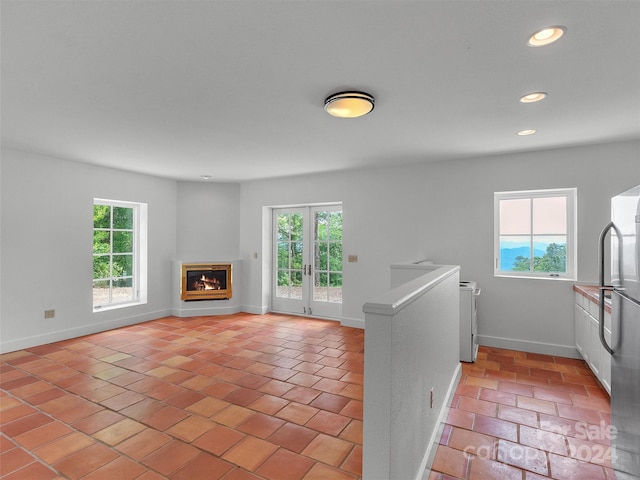 unfurnished living room featuring french doors