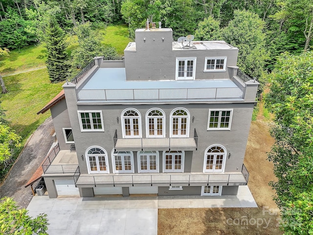 back of house with a balcony, a patio area, and french doors