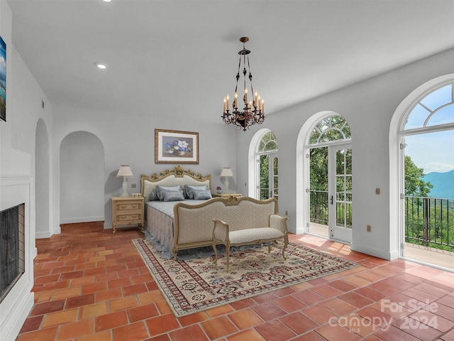 bedroom with multiple windows, access to outside, and a chandelier