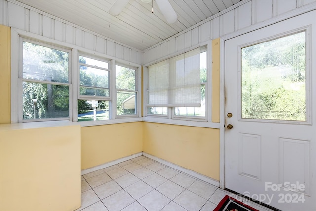 unfurnished sunroom with ceiling fan and a wealth of natural light