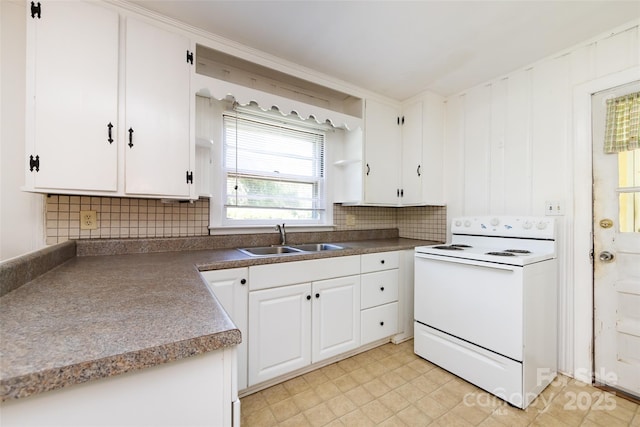 kitchen featuring white electric stove, tasteful backsplash, a sink, and white cabinets