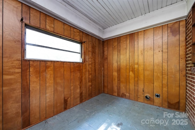 spare room with wooden walls