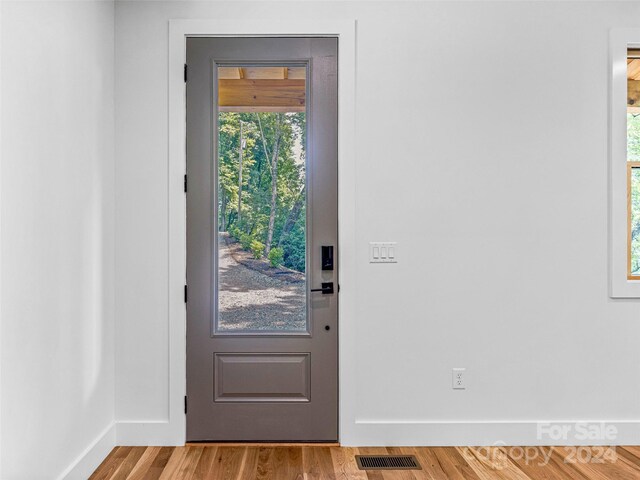 doorway to outside with plenty of natural light and hardwood / wood-style floors