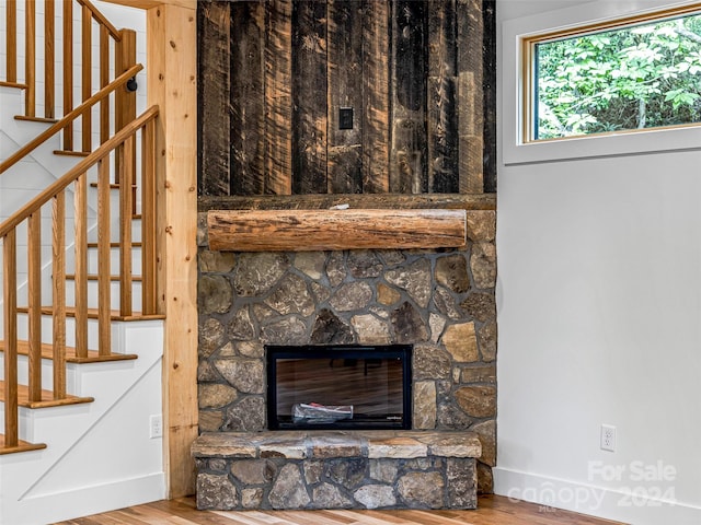 details featuring a stone fireplace and hardwood / wood-style flooring