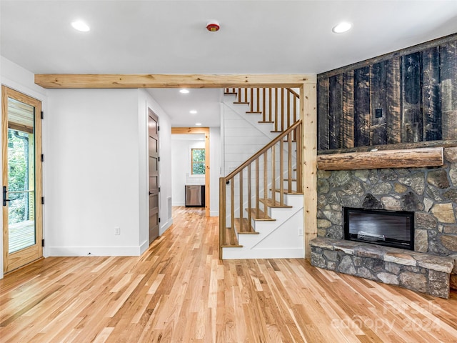 entryway with a fireplace and light hardwood / wood-style floors