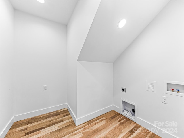 washroom with light hardwood / wood-style flooring, hookup for a washing machine, and electric dryer hookup