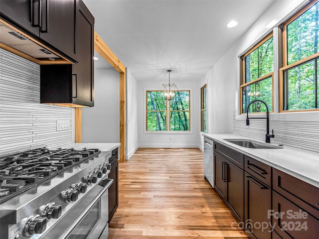 kitchen with decorative backsplash, appliances with stainless steel finishes, light hardwood / wood-style flooring, and a wealth of natural light