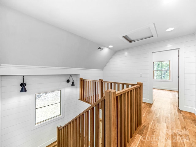 hall featuring lofted ceiling and wood-type flooring