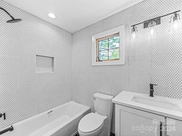 full bathroom with tiled shower / bath combo, toilet, and vanity