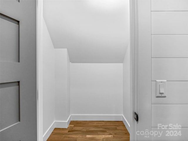 interior space featuring hardwood / wood-style flooring and vaulted ceiling