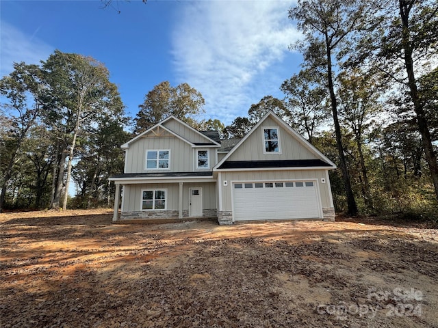 craftsman house with a garage and covered porch