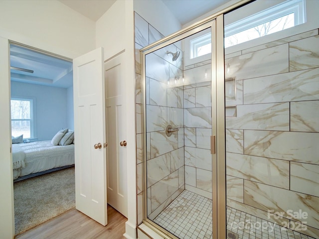 bathroom featuring a shower with door and hardwood / wood-style flooring