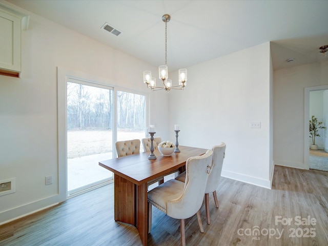 dining room featuring a chandelier and light hardwood / wood-style floors