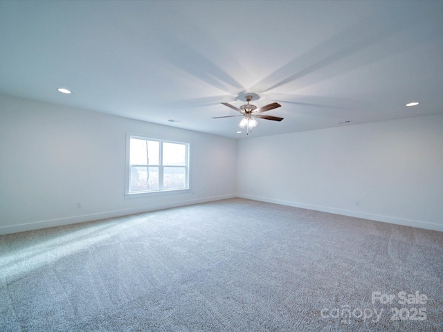 carpeted spare room featuring ceiling fan