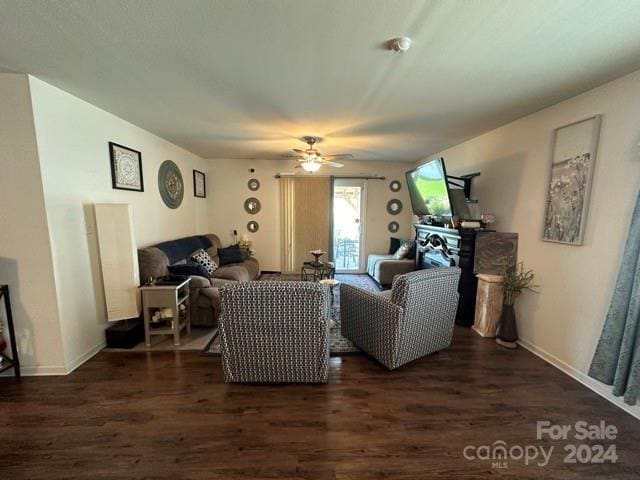 living room with dark hardwood / wood-style flooring and ceiling fan