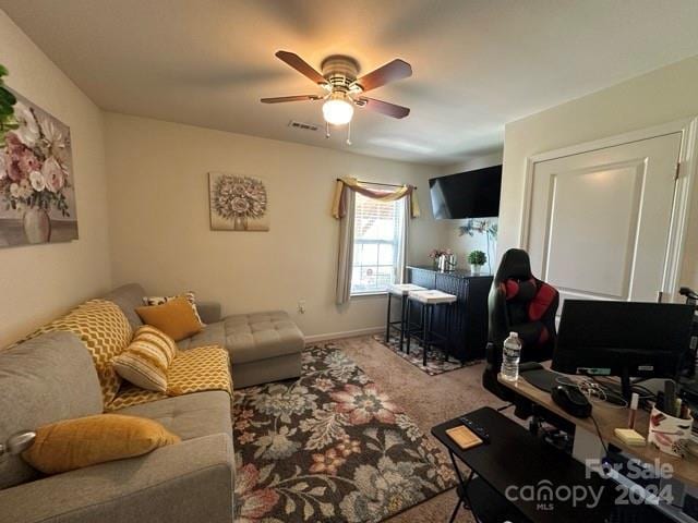 living room featuring ceiling fan and carpet floors