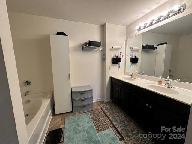 bathroom with a washtub and vanity