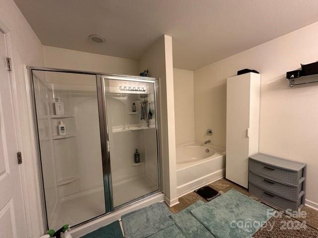 bathroom featuring plus walk in shower