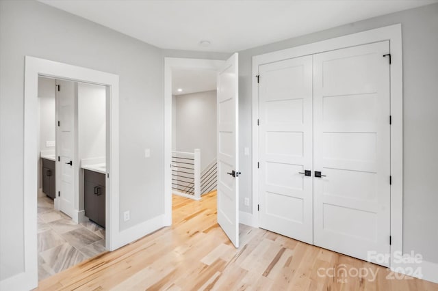 bedroom with a closet and light hardwood / wood-style flooring