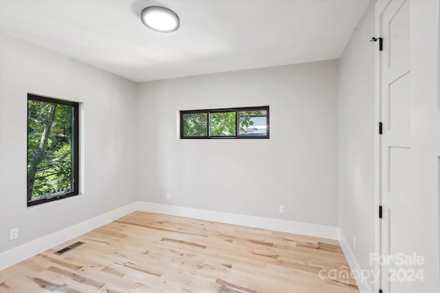 unfurnished room with light hardwood / wood-style floors