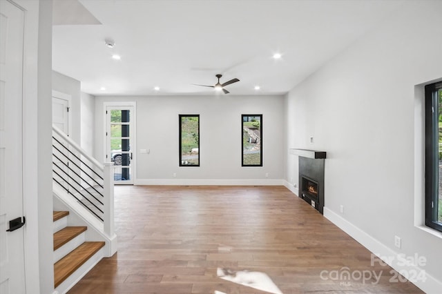 unfurnished living room featuring light wood-type flooring and ceiling fan