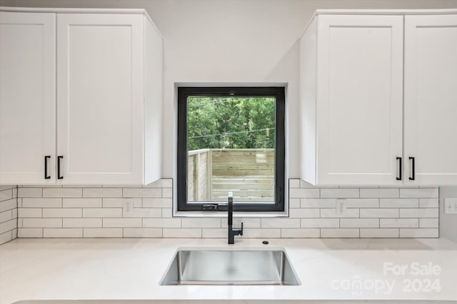 kitchen with sink and white cabinetry