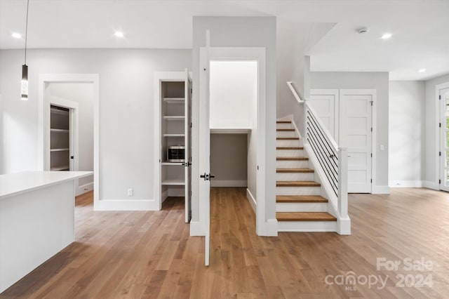 staircase with wood-type flooring