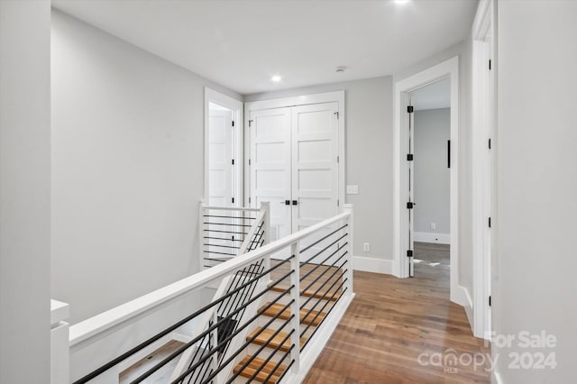 corridor with hardwood / wood-style floors